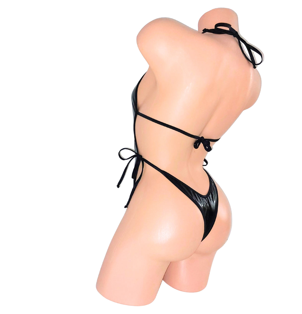 Rear view of a black Vinyl wet look vinyl one piece backless leotard bodysuit on a plastic beige mannequin torso against a plain background.