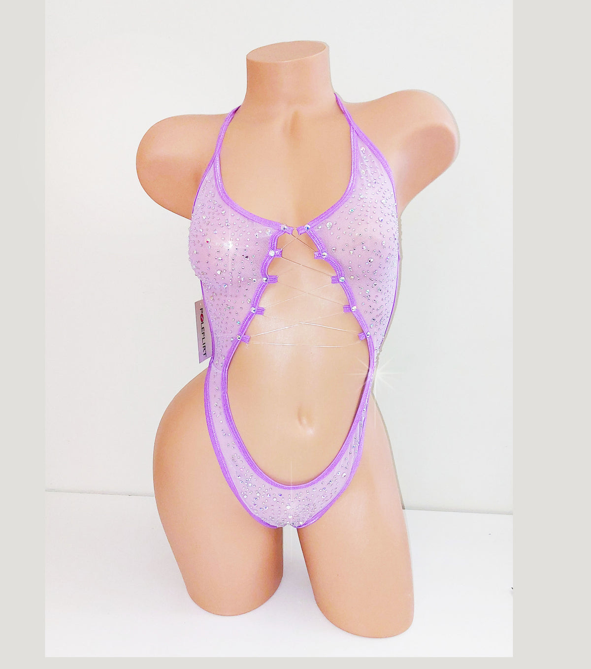 Lavender purple mesh one piece bodysuit leotard on a plastic beige mannequin, coveed in multi-sized rhinestones, against a blank background.