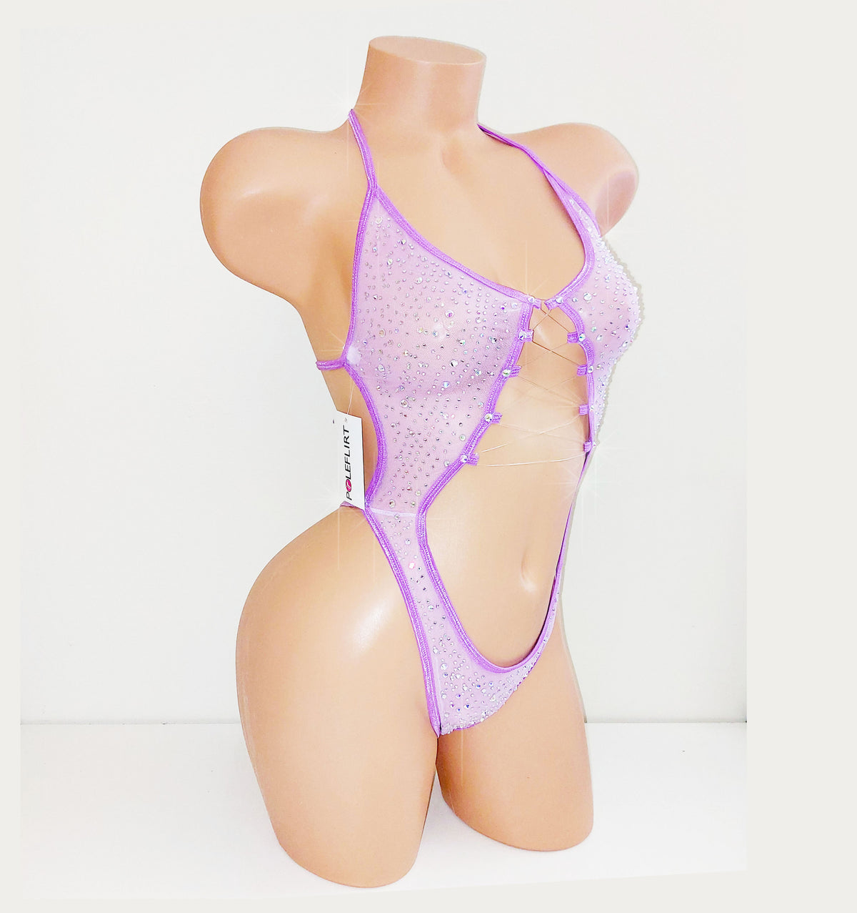 Lavender purple mesh one piece bodysuit leotard on a plastic beige mannequin, coveed in multi-sized rhinestones, against a blank background.