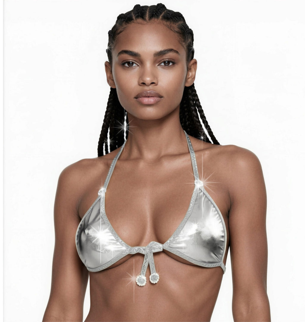A model wearing a metallic silver bikini top with diamond circle accents on the adjustable straps against a white backdrop.