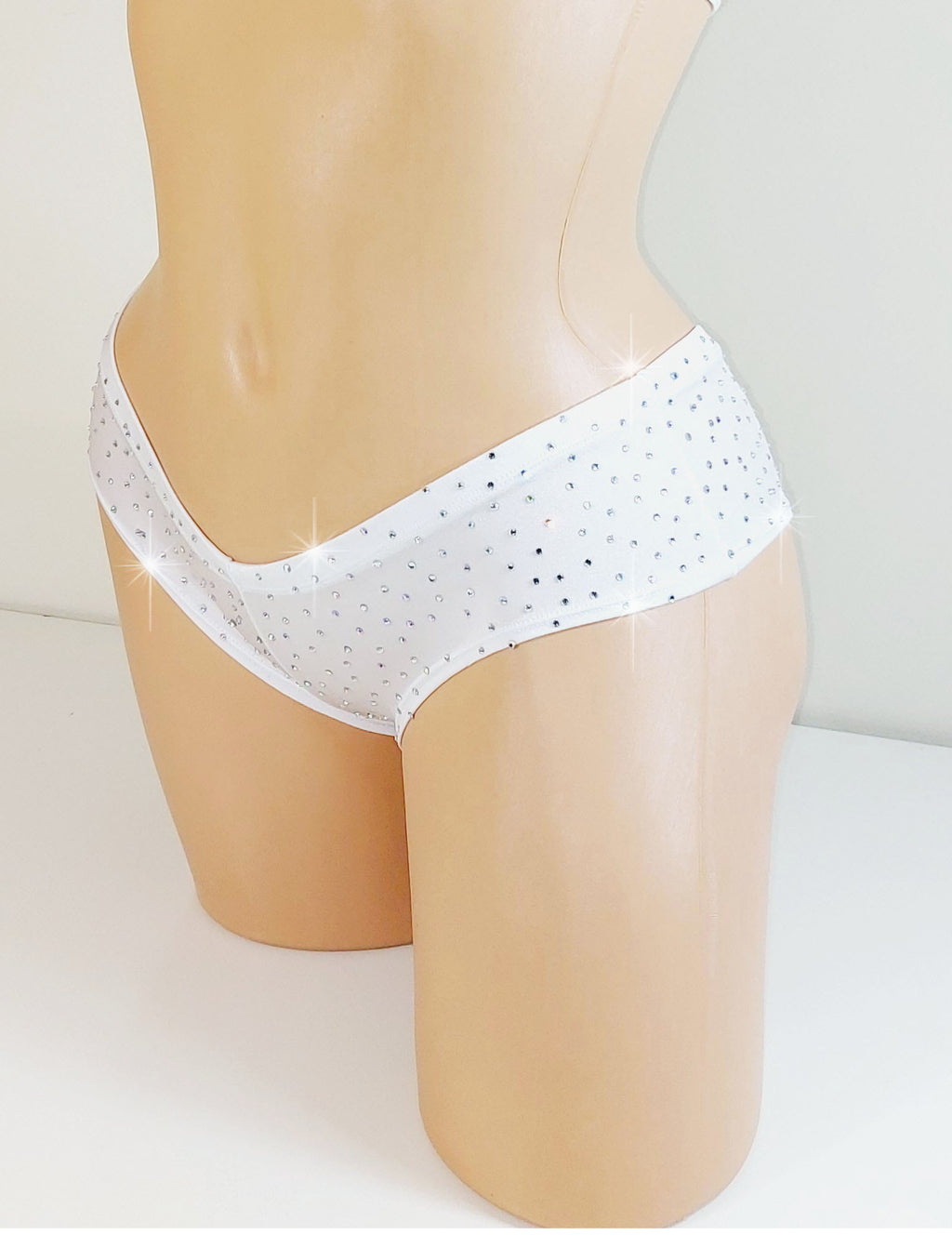 White boyshorts bikini bottom with small rhinestones  on a plain background