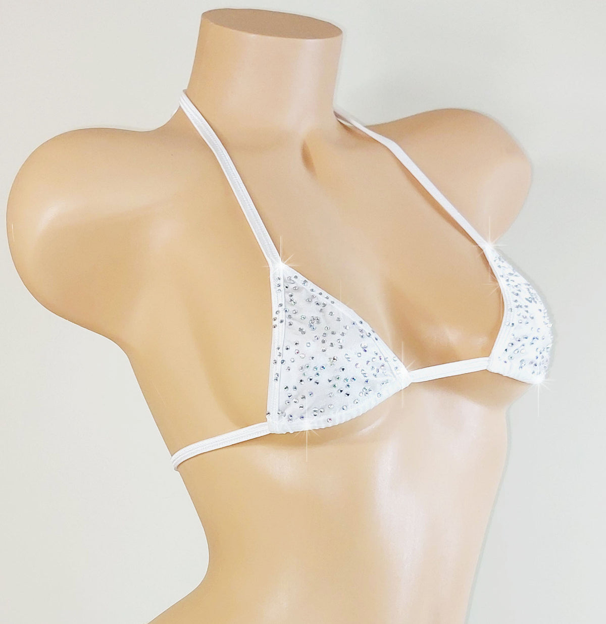 White bedazzled rhinestone bikini top with thin straps on a mannequin against a light gray background
