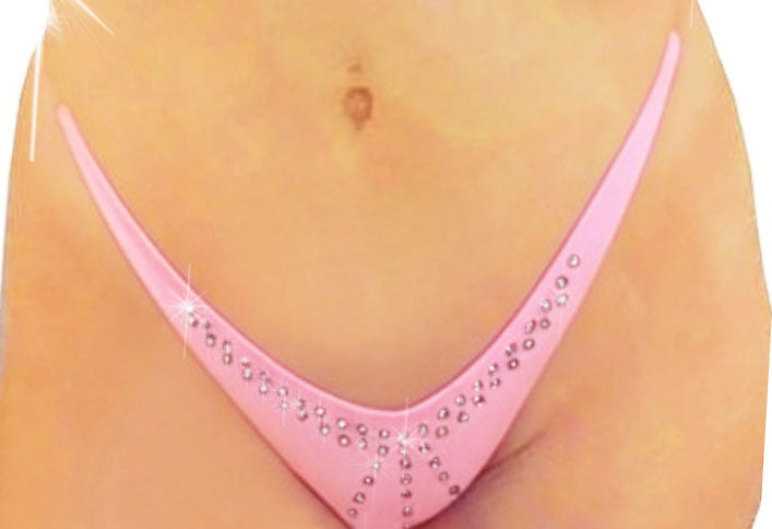 A beige mannequin displaying a minimal coverage pink tiny micro bikini bottom with a sparklling design of rhinestones along the center and sides. 