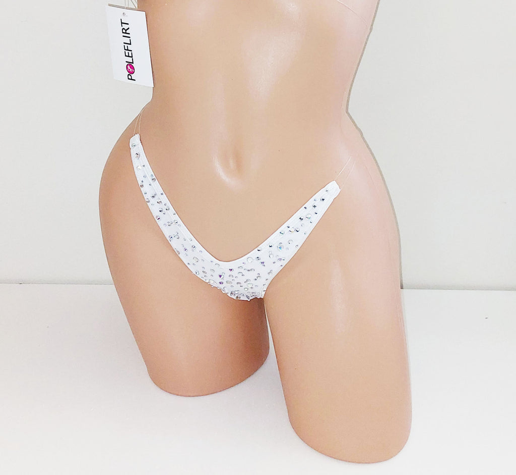 White thong underwear rhinestones, displayed on a beige female mannequin torso. A white brand tag for 'PoleFlirt' is attached near the waistband.