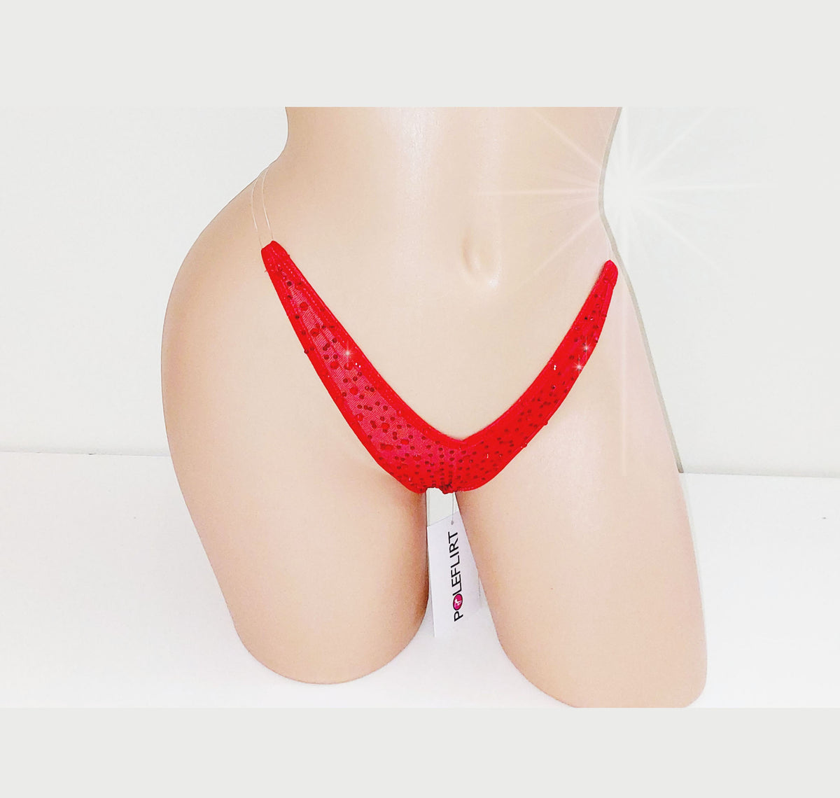 Plastic mannequin torso displaying a tiny red micro thong with clear elastic straps that look invisible and it is covered in sparkling red rhinestones.