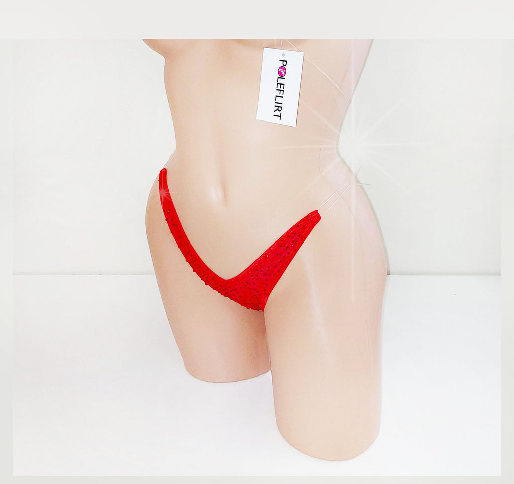A tiny red micro thong with clear elastic straps that look invisible and it is covered in sparkling red rhinestones displayed a plastic mannequin torso against a plain background.