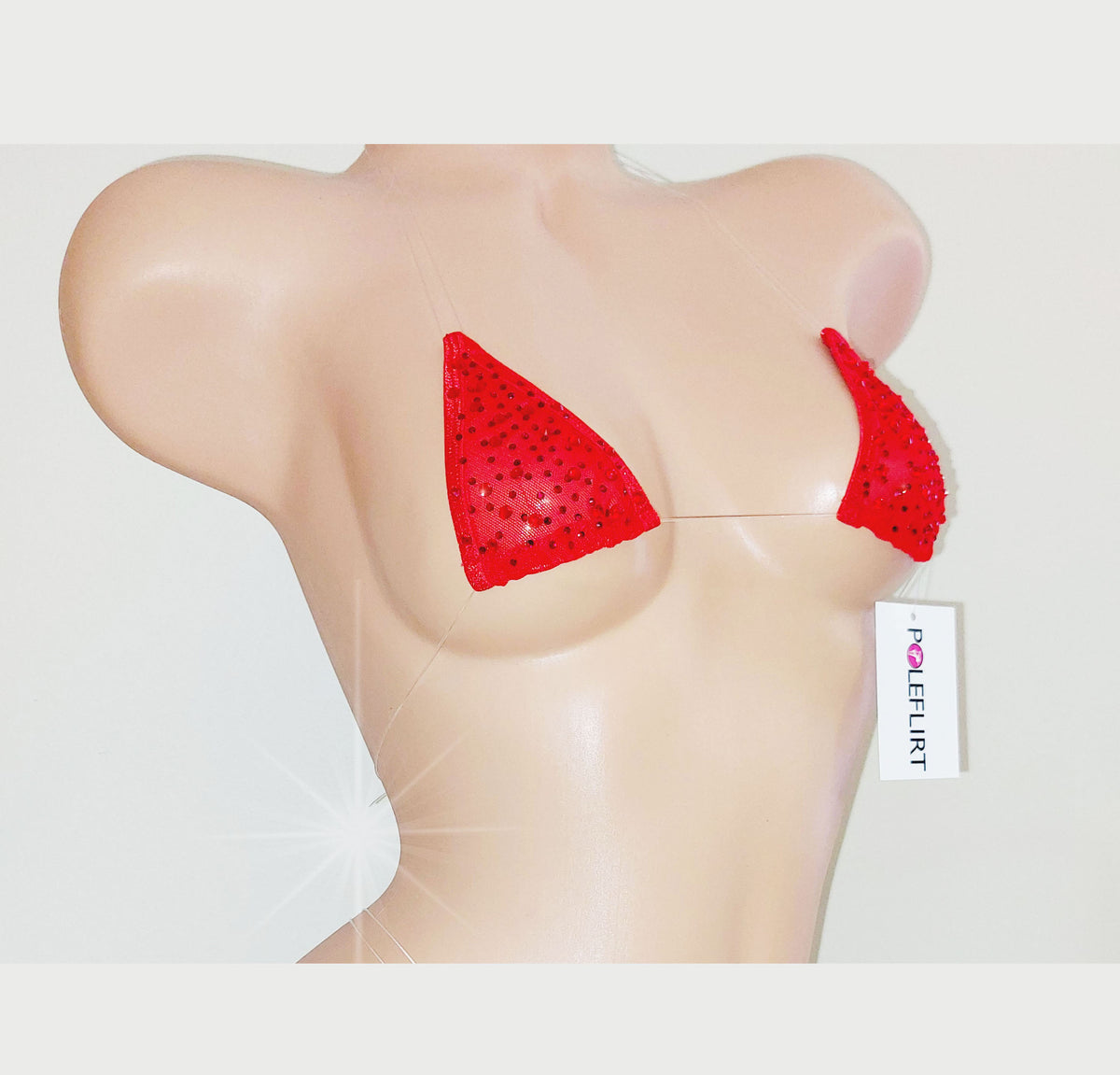 Red triangle bikini bra cups with rhinestone embellishments, displayed on a beige mannequin torso against a light gray background. A white tag with the brand name 'POLEFLIRT' is attached to the right cup.