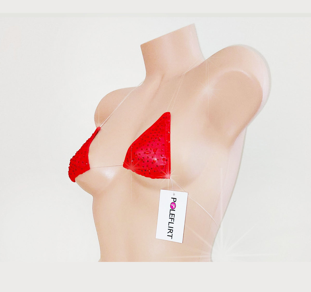 A red triangle bra with sequins displayed on a beige mannequin torso against a light gray background. A white hangtag with the brand name 'POLEFLIRT' is attached to the front.