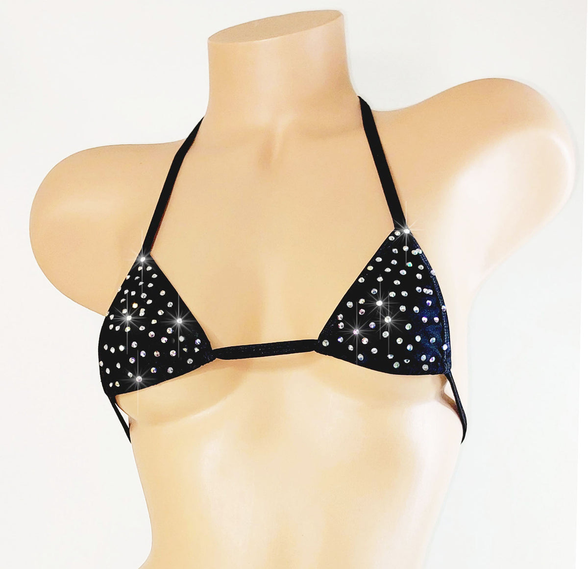 Black bikini top with sparkling details on a mannequin against a white background