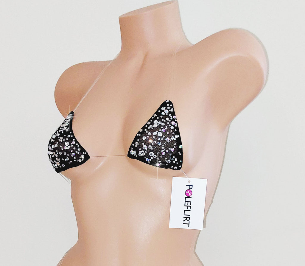 Sparkling crystal gem bedazzled rhinestone tiny micro swim top on a plastic beige mannequin torso on a plain background.