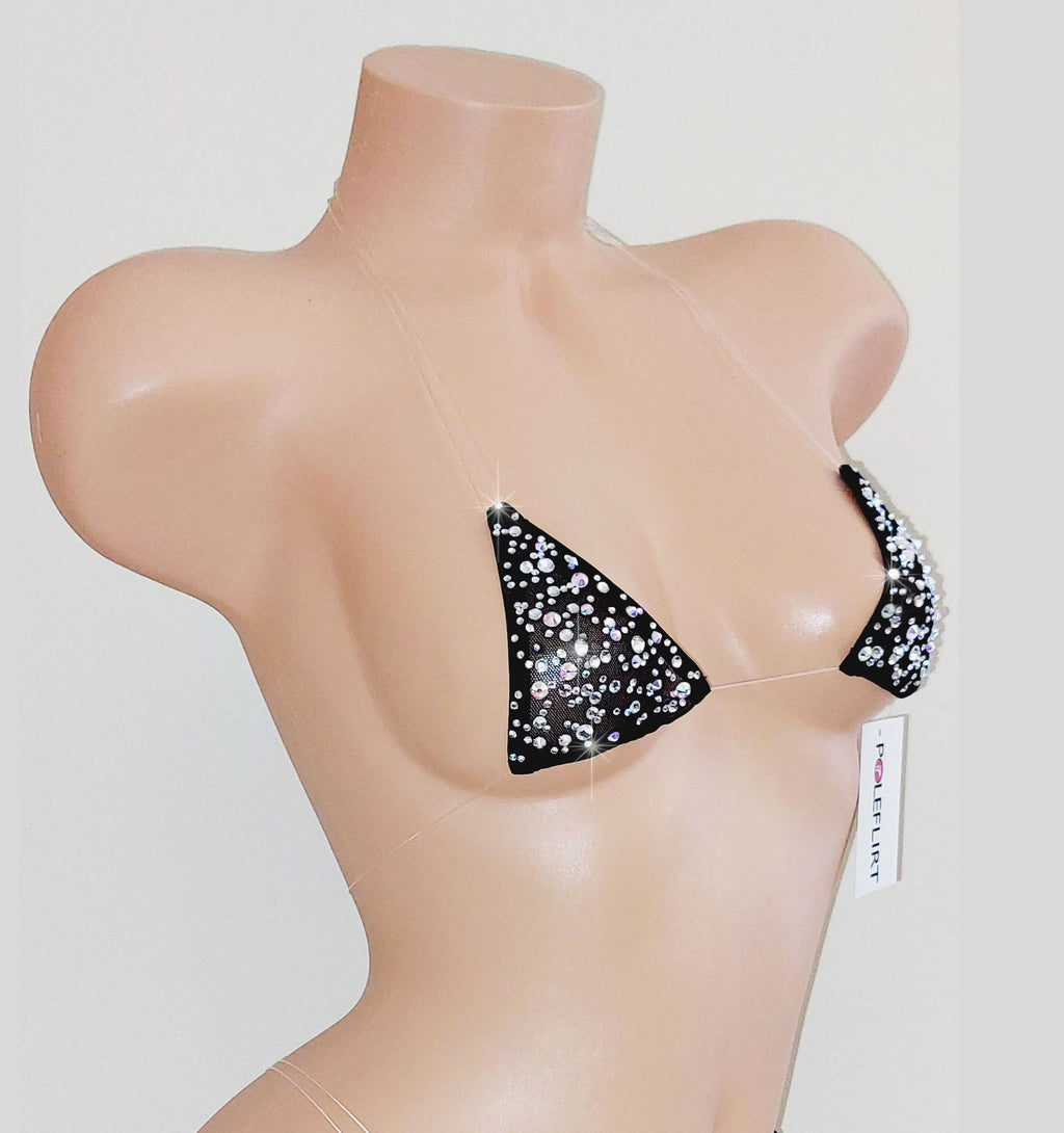 A ton of sparkling rhinestones  on a tiny micro bikini top with clear straps with a hang tag reading POLEFLIRT on a plastic beige mannequin torso on a plain background.