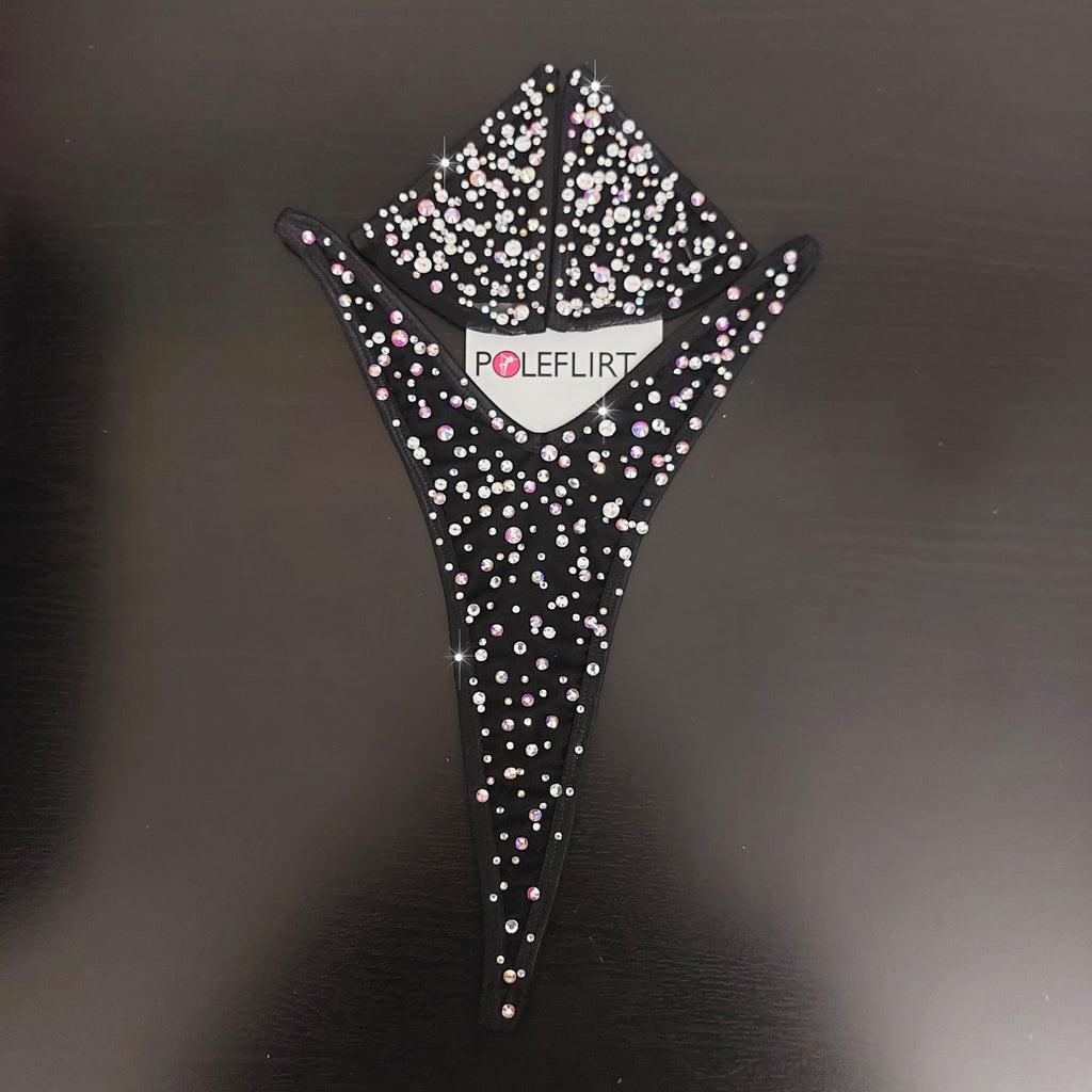 Product shot of a black tiny swim micro bikini set totally bedazzled with with crystal gem rhinestones laid flat on a dark background wiht a hang tag reading POLEFLIRT.