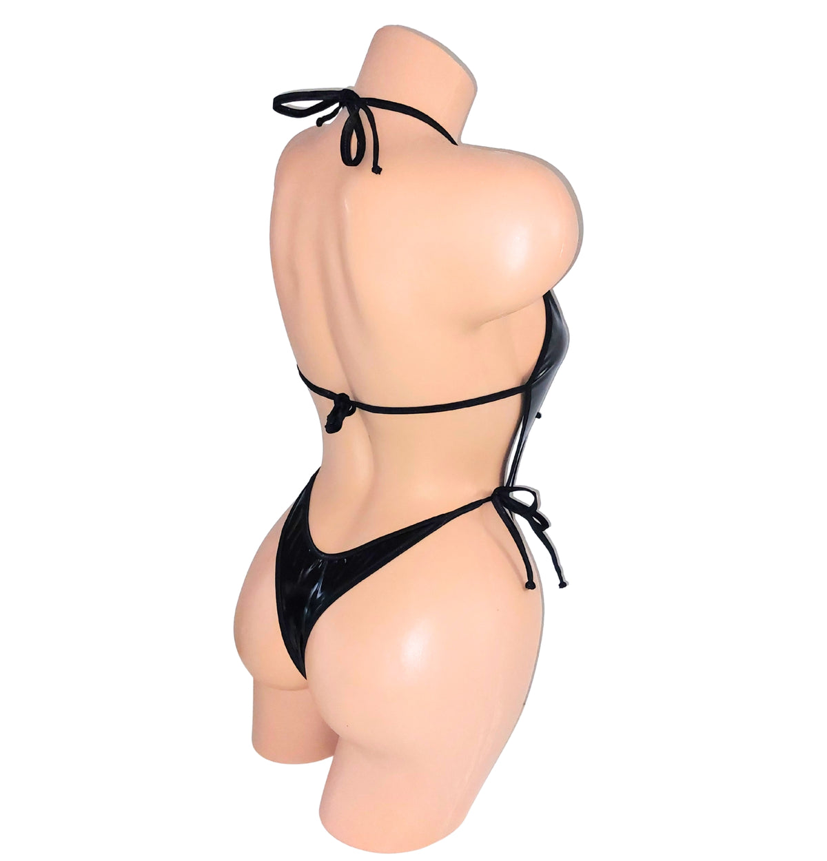 Rear view of a black Vinyl wet look vinyl one piece backless leotard bodysuit on a plastic beige mannequin torso against a plain background.