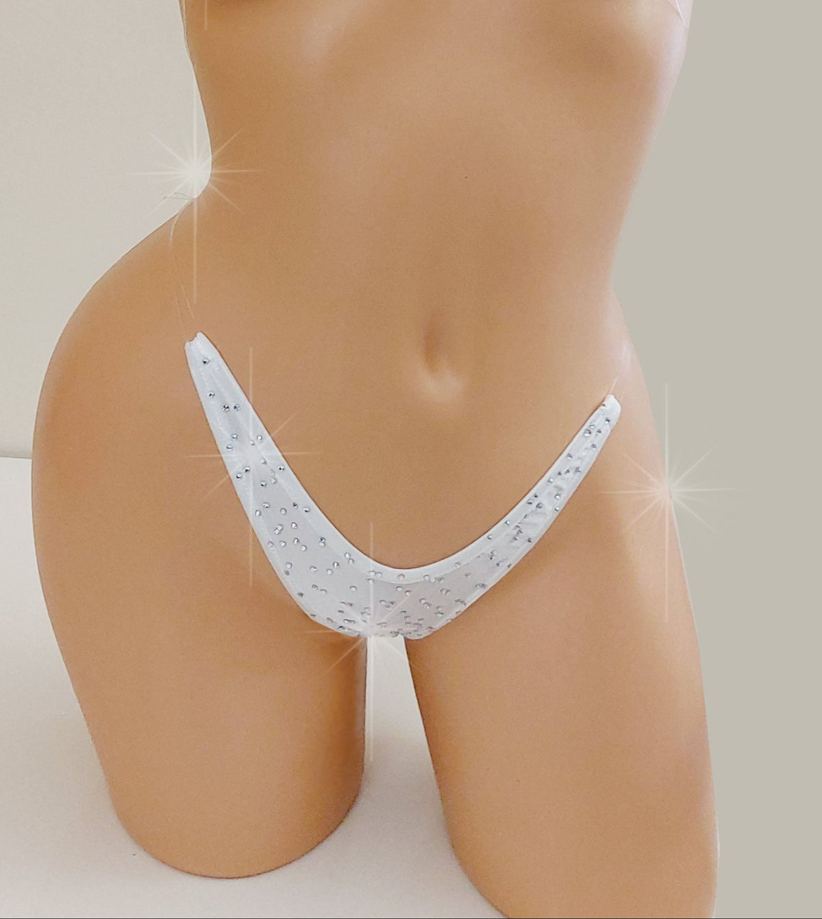 White bikini g-string thong with clear straps and rhinestones.