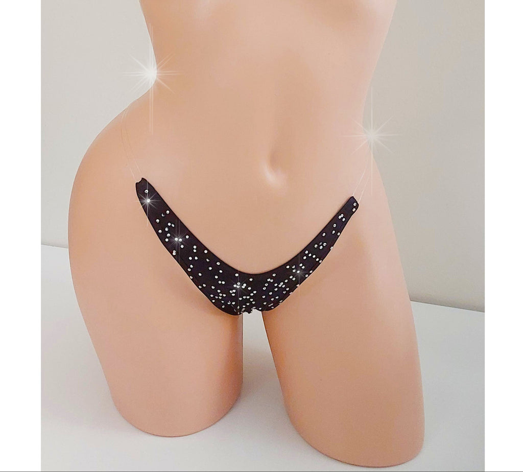 Black invisible strap micro bikini g-string thong covered in rhinestones on a torso mannequin on a white background.