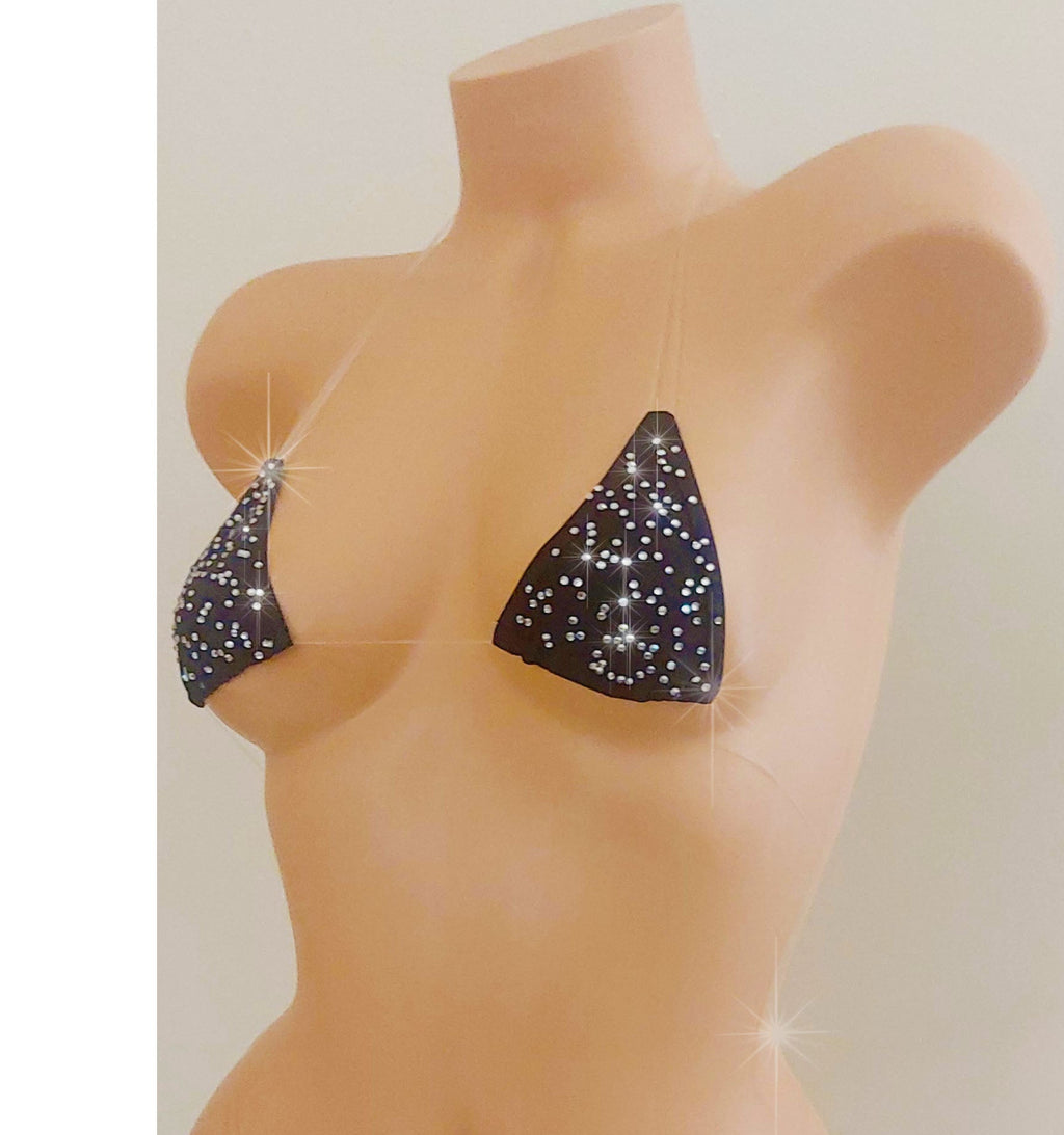 Black invisible straps micro bikini covered in rhinestones on a torso mannequin on a white background.