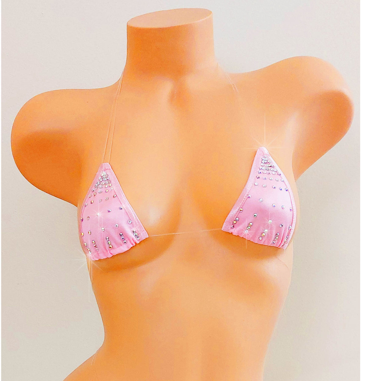 Baby Pink rhinestone bikini top with clear straps that appear invisible, on a female torso mannequin against a blank background.