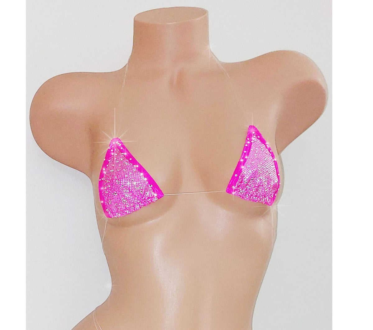 A beige mannequin torso displaying a vibrant pink hologram minimal coverage clear elastic micro tiny swim bikini top.