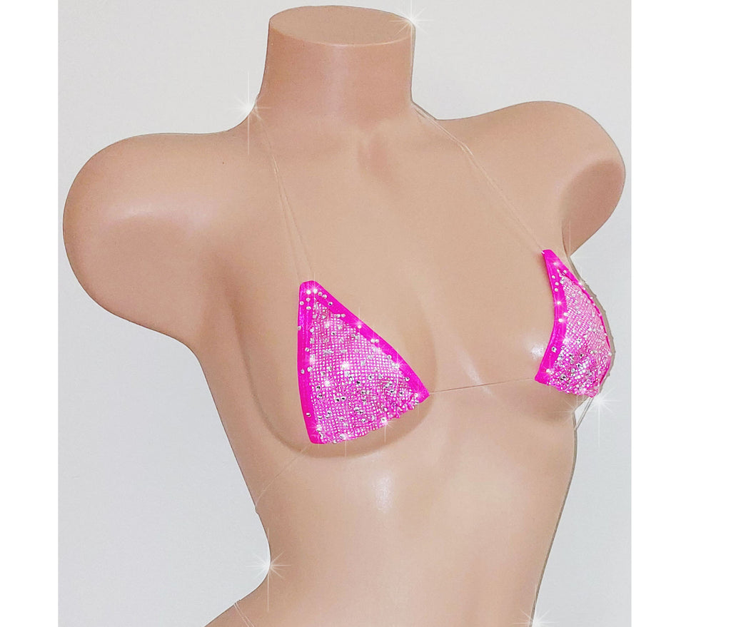 A beige mannequin torso displaying a vibrant pink hologram minimal coverage clear elastic micro tiny swim bikini top.
