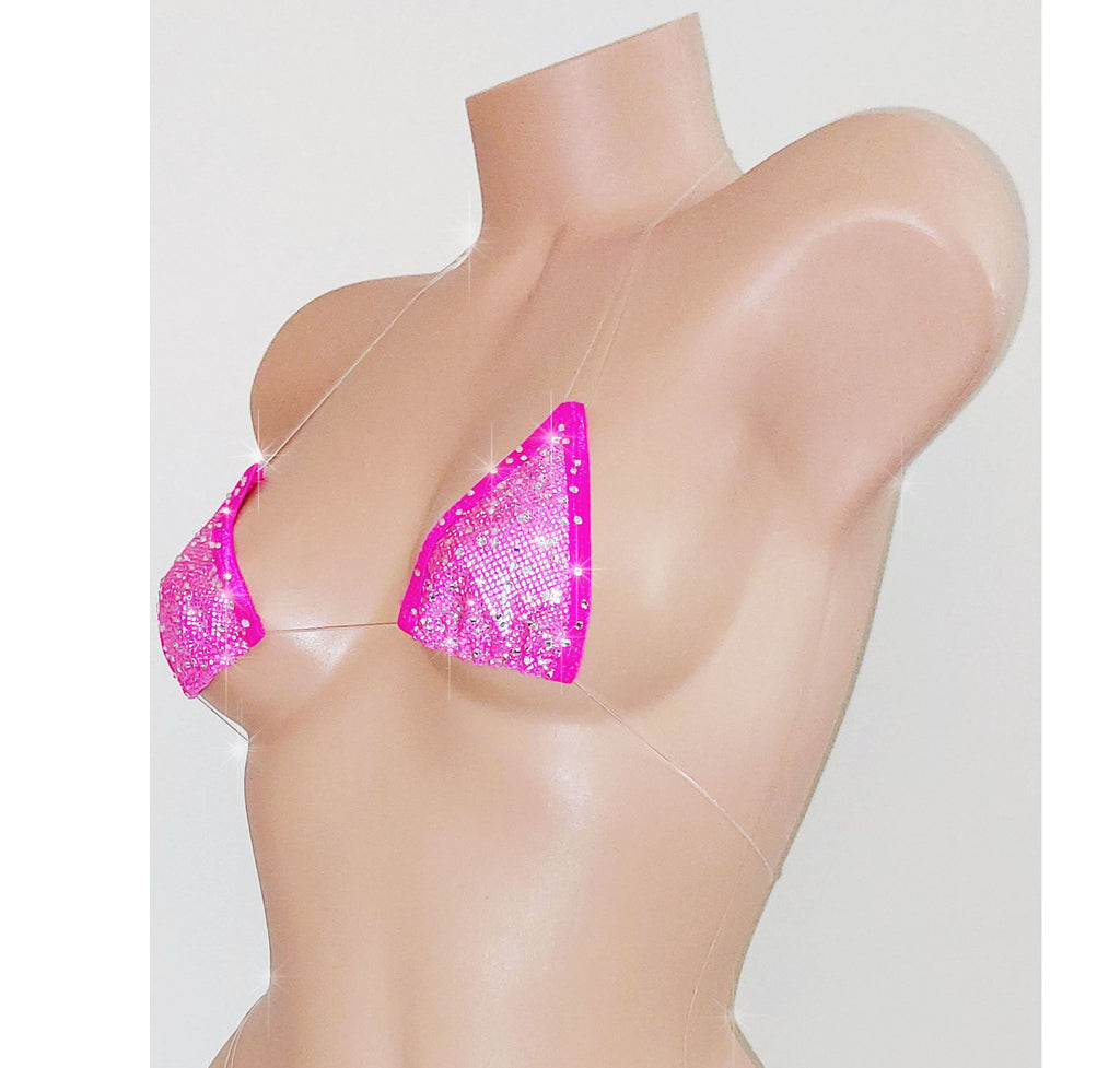 A beige mannequin torso displaying a vibrant pink hologram minimal coverage clear elastic micro tiny swim bikini top.