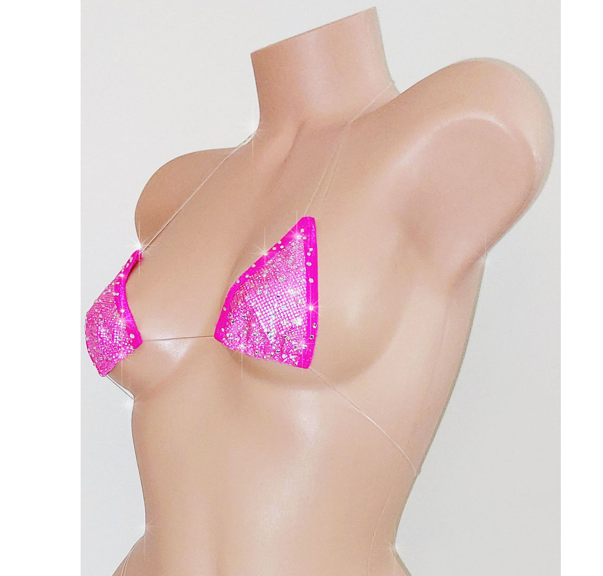 A beige mannequin torso displaying a vibrant pink hologram minimal coverage clear elastic micro tiny swim bikini top.