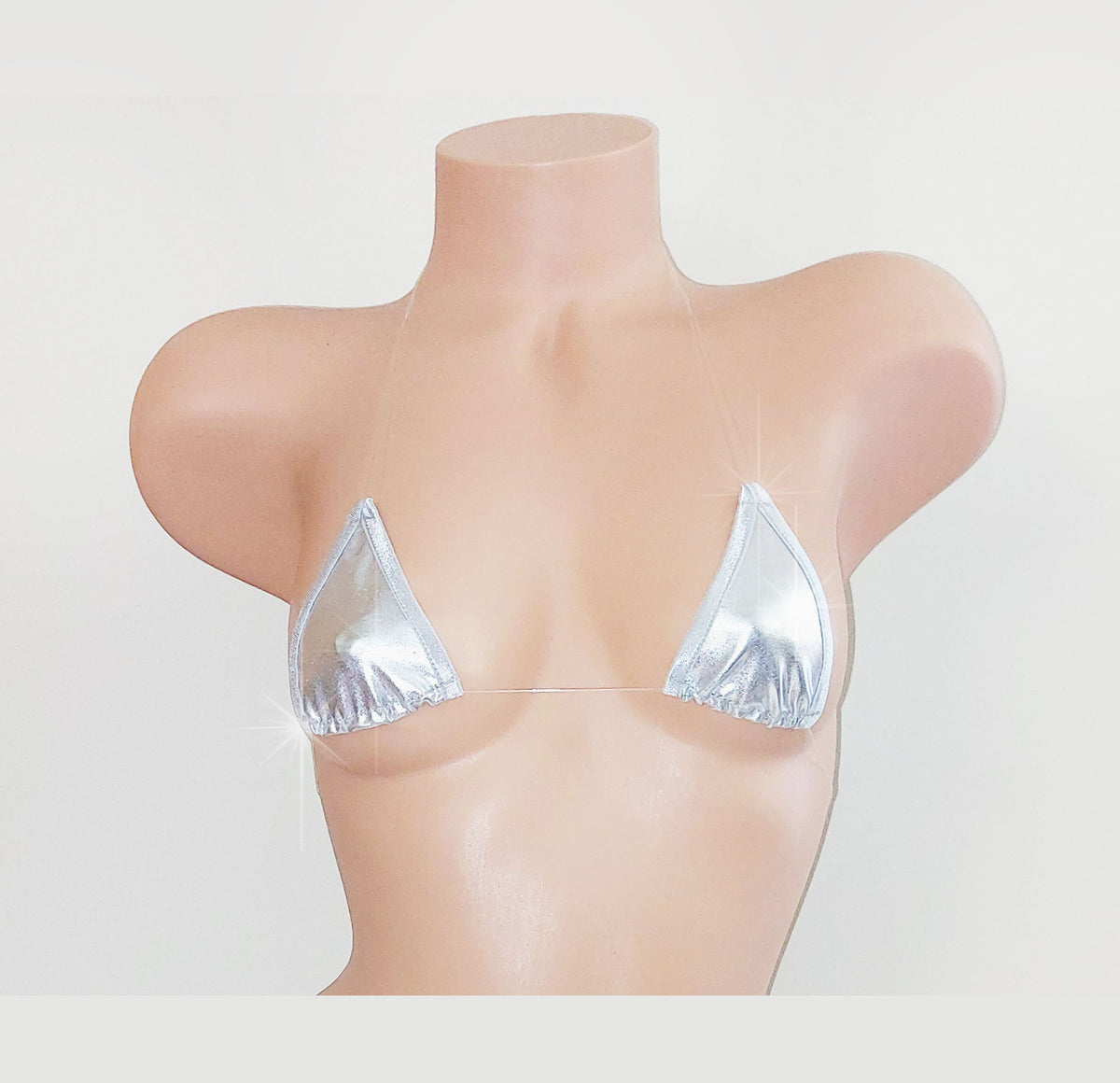 A metallic silver triangle bikini top displayed on a beige mannequin torso against a plain white background.